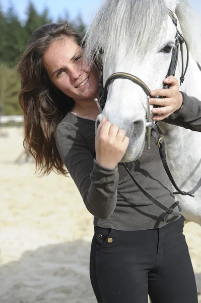   Woman playing with her horse — Stockfoto